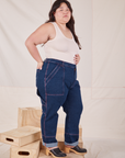 Side view of Carpenter Jeans in Dark Wash and Tank Top in vintage tee off-white worn by Ashley
