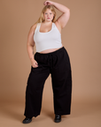 Juliet is 5’7” and wearing 1XL Drop Pocket Cargo Pants in Basic Black paired with a Cropped Tank in vintage tee white