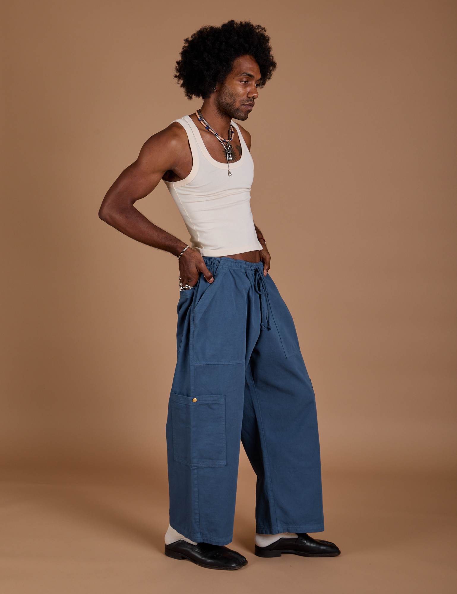 Angled front view of Drop Pocket Cargo Pants in French Blue and Tank Top in vintage tee white on Jerrod