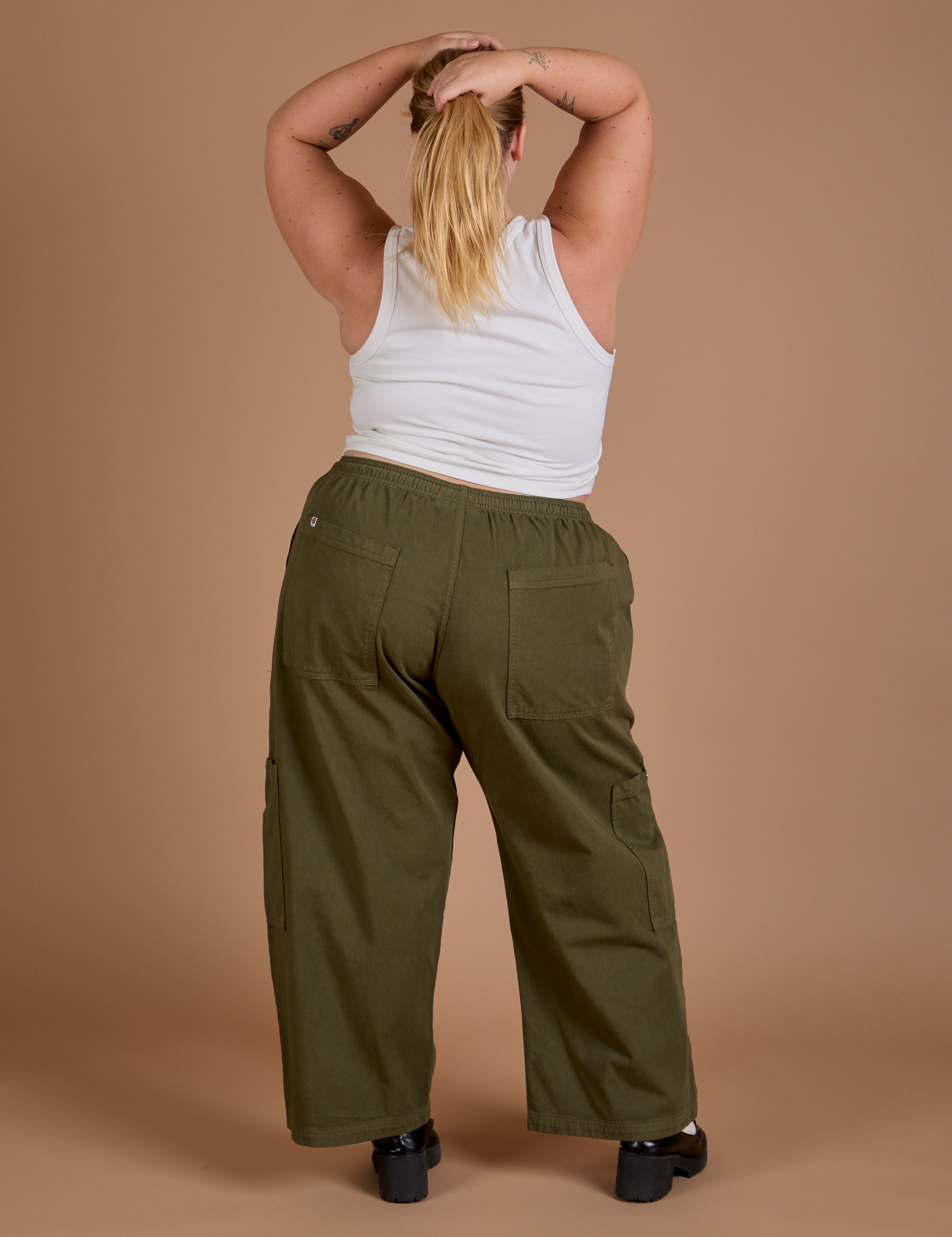 Back view of Drop Pocket Cargo Pants in Surplus Green and Cropped Tank in Vintage Tee White