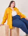Marielena is wearing Flannel Overshirt in Mustard Yellow and dark wash Trouser Jeans