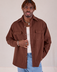 Isaac is 5'10" and wearing S Flannel Overshirt in Fudgesicle Brown