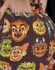 Close up of Alex's hand in the back pocket of Short Sleeve Jumpsuit in Halloween Masks