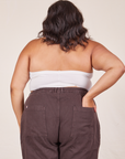 Back view of Halter Top in Vintage Off-White and espresso brown Western Pants worn by Alicia. She has her left hand in the back of the pant pocket.