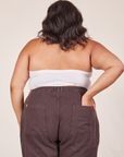 Back view of Halter Top in Vintage Tee Off-White and espresso brown Western Pants worn by Alicia. She has her left hand in the back of the pant pocket.