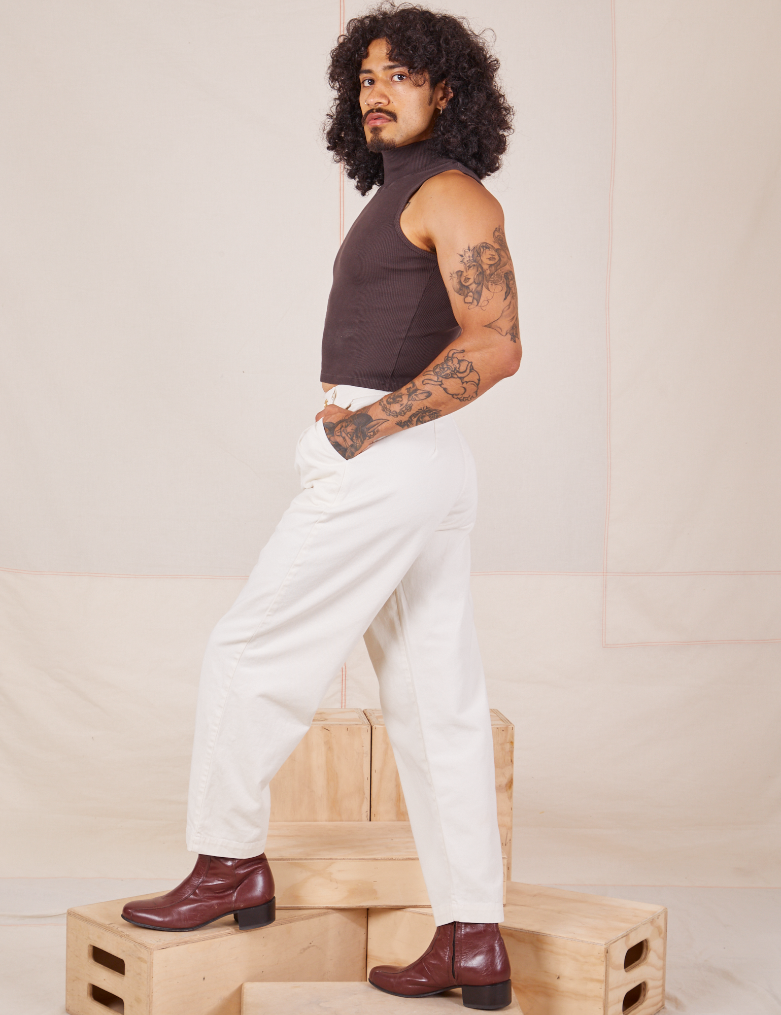 Side view of Heavyweight Trousers in Vintage Tee Off-White and espresso brown Sleeveless Turtleneck worn by Jesse