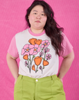 Ashley is 5’7” and wearing L Anniversary Tee in Pink Poppy