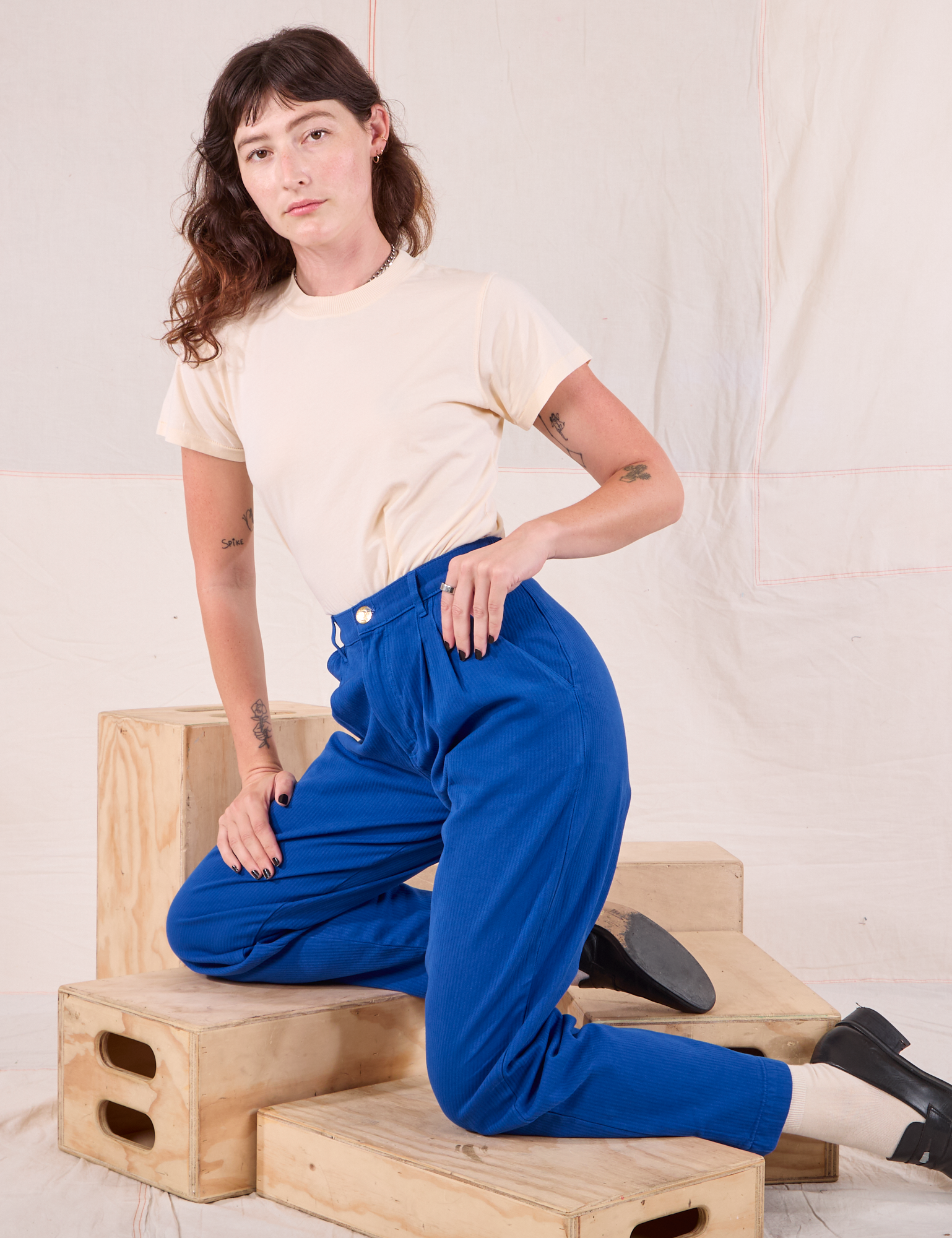 Alex is wearing Heritage Trousers in Royal Blue and Organic Vintage Tee in vintage tee off-white