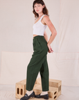 Side view of Heritage Trousers in Swamp Green and Cropped Tank in vintage tee off-white on Alex