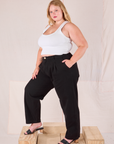 Angled front view of Heritage Trousers in Basic Black and Cropped Tank in vintage tee off-white