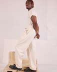Side view of Heritage Trousers in Natural and Organic Vintage Tee in vintage tee off-white
