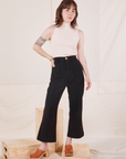 Hana is 5'3" and wearing XXS Petite Heritage Westerns in Basic Black paired with Sleeveless Turtleneck in vintage tee off-white