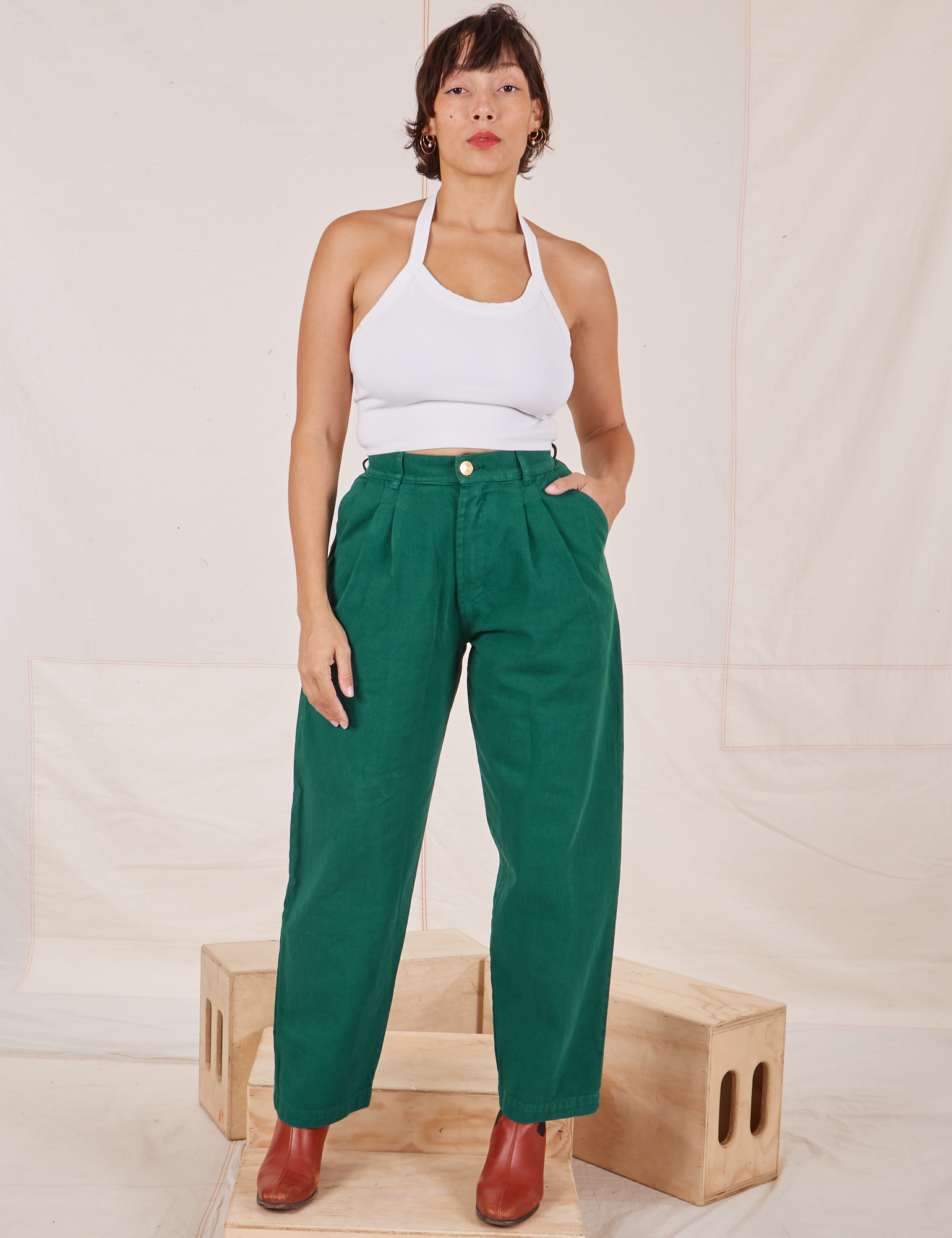 Tiara is 5&#39;4&quot; and wearing XS Heavyweight Trousers in Hunter Green paired with Halter Top in vintage tee off-white