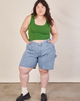Ashley is 5'7" and wearing 1XL Carpenter Shorts in Light Wash paired with lawn green Cropped Tank
