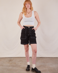 Margaret is 5'11" and wearing XS Carpenter Shorts in Basic Black paired with a Cropped Tank in vintage tee off-white