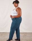 Side view of Work Pants in Lagoon and vintage tee off-white Tank Top