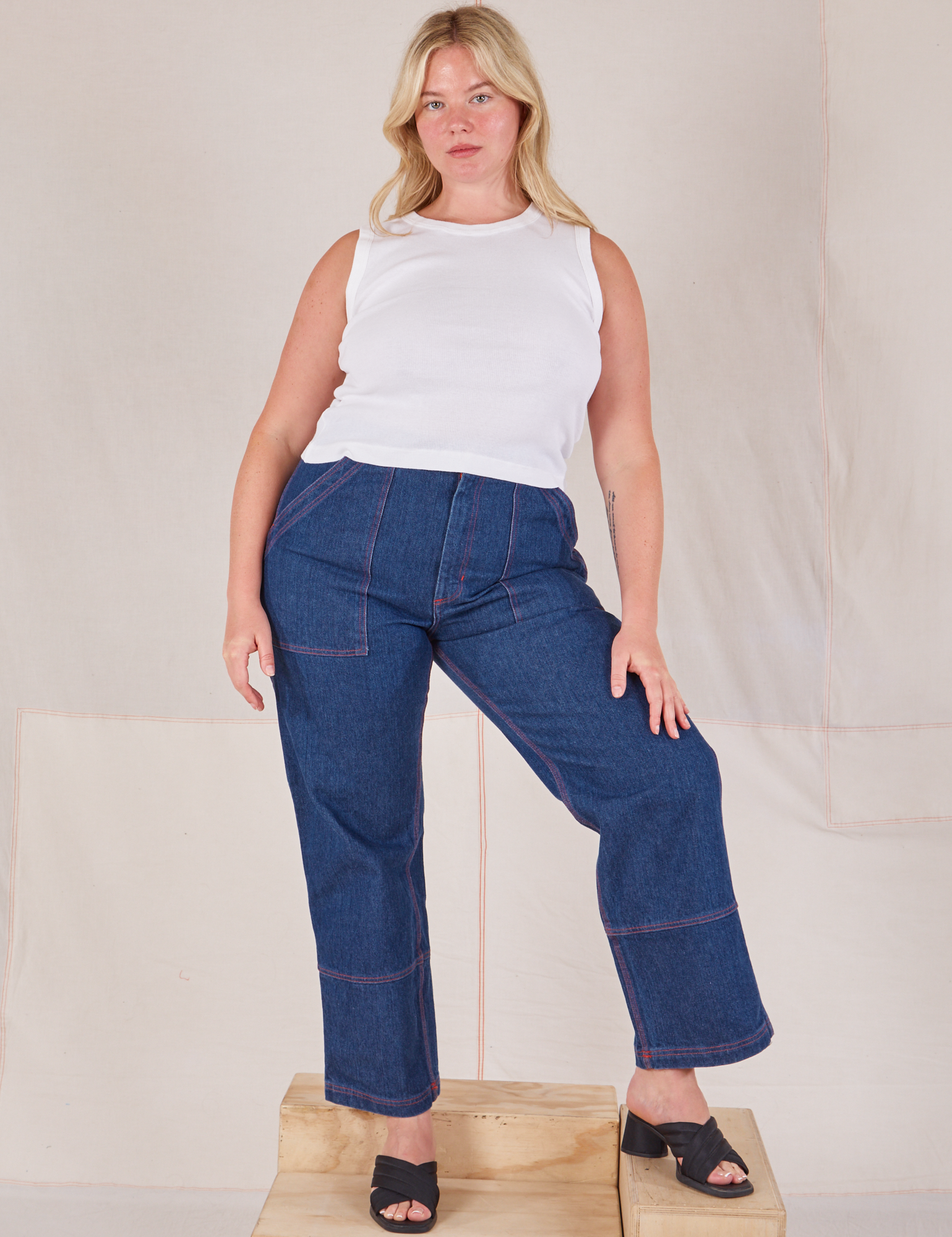 Lish is wearing Muscle Tee in Vintage Tee Off-White and dark wash Carpenter Jeans