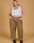 Juliet is 5'7" and wearing 1XL Baggy Mid-Rise Trousers in Desert Brown paired with a vintage tee white Cropped Tank