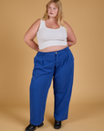 Juliet is 5'7" and wearing 1XL Baggy Mid-Rise Trousers in Royal Blue paired with a vintage tee white Cropped Tank