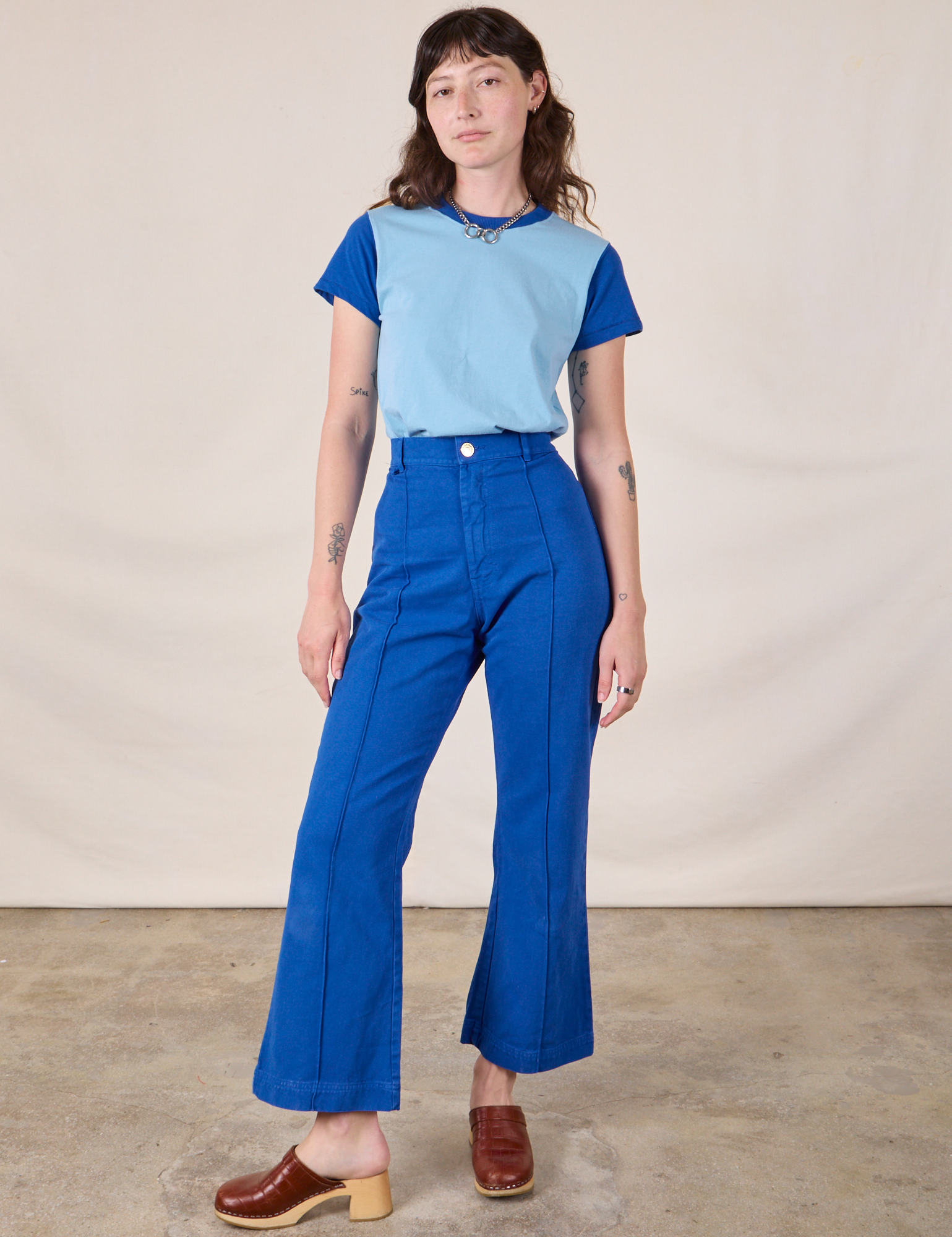 Alex is wearing Mismatched Tee in Baby & Royal Blue and royal blue Western Pants