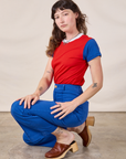 Alex is wearing Mismatched Tee in Red & Blue tucked into royal blue Western Pants
