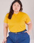 Ashley is 5'7" and wearing L Organic Vintage Tee in Sunshine Yellow tucked into dark wash Trouser Jeans