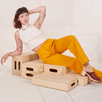 Organic Trousers in Mustard Yellow and vintage off-white Sleeveless Essential Turtleneck worn by Alex