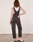 Back view of Original Overalls in Mono Espresso and Cropped Tank Top in vintage tee off-white worn by Alex.