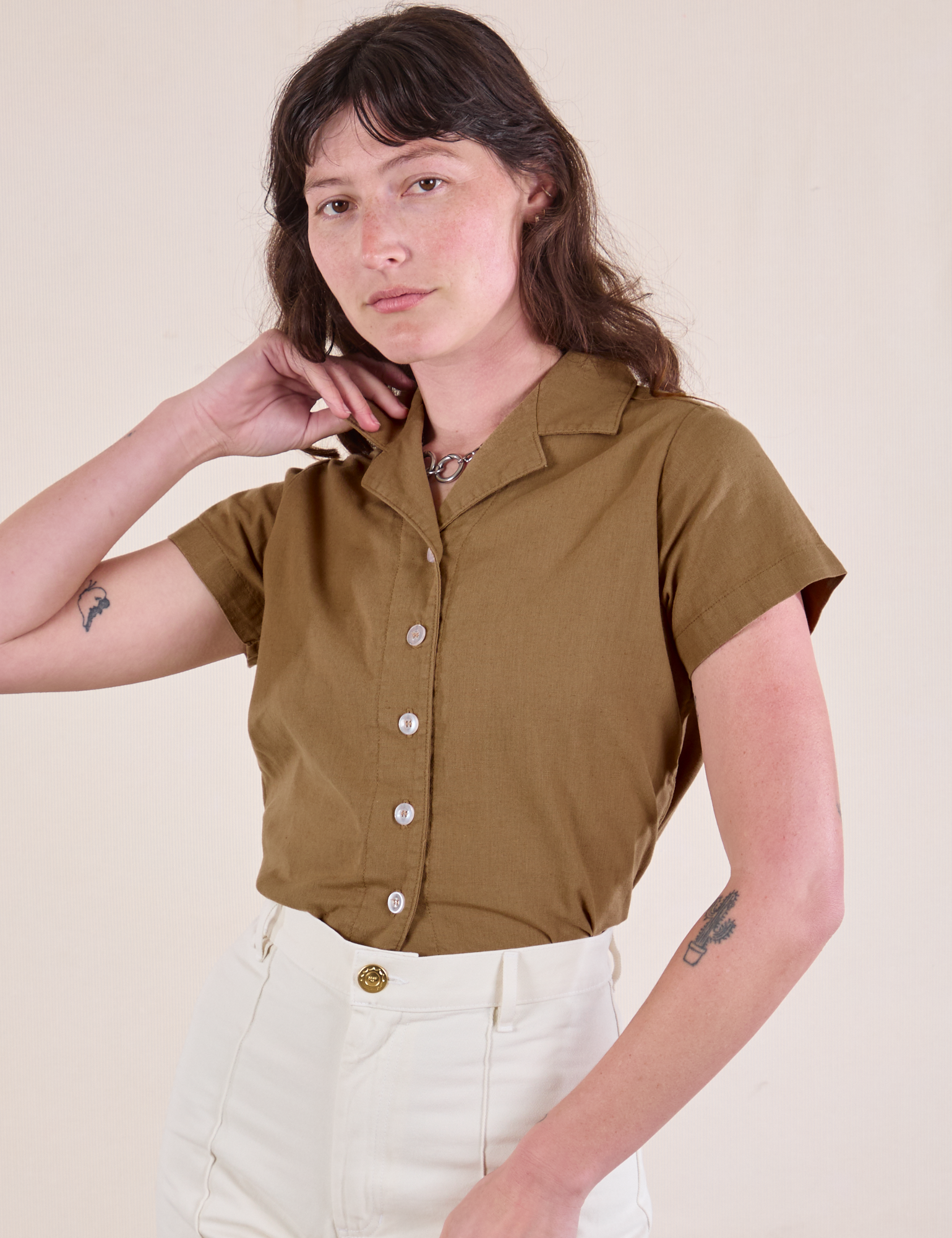 Alex has the Pantry Button-Up in Desert Brown tucked into vintage tee off-white Western Pants