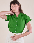 Alex is wearing a Pantry Button-Up in Kelly Green tucked into vintage tee off-white Western Pants