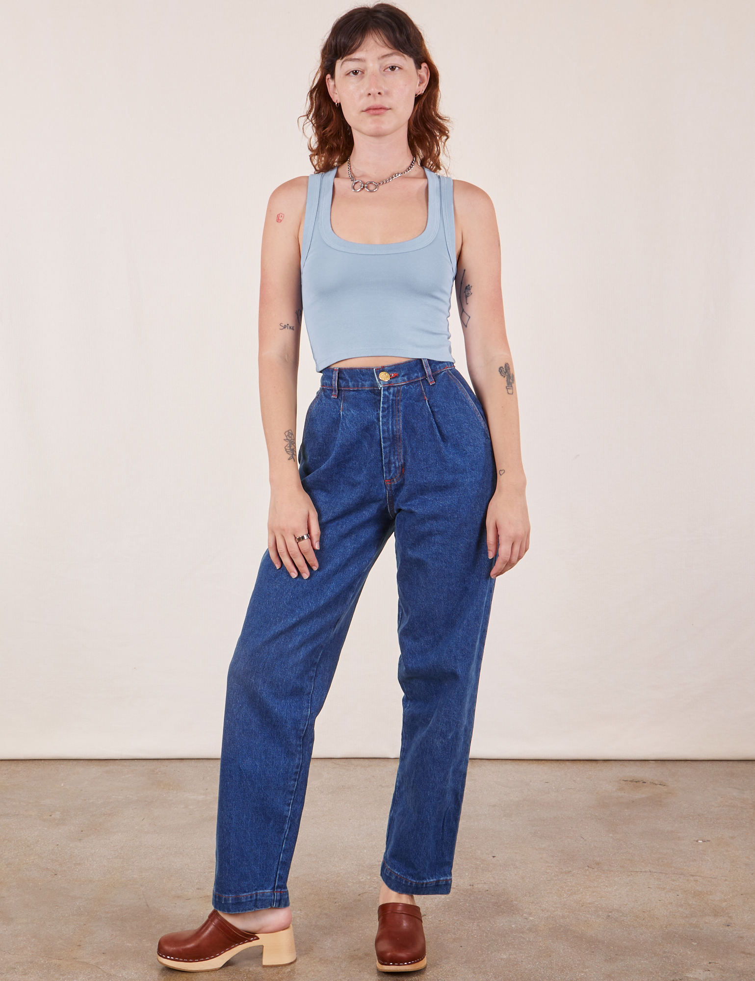 Alex is wearing Cropped Tank Top in Periwinkle and dark wash Denim Trouser Jeans