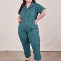 Ashley is 5’7” and wearing 1XL Petite Short Sleeve Jumpsuit in Marine Blue