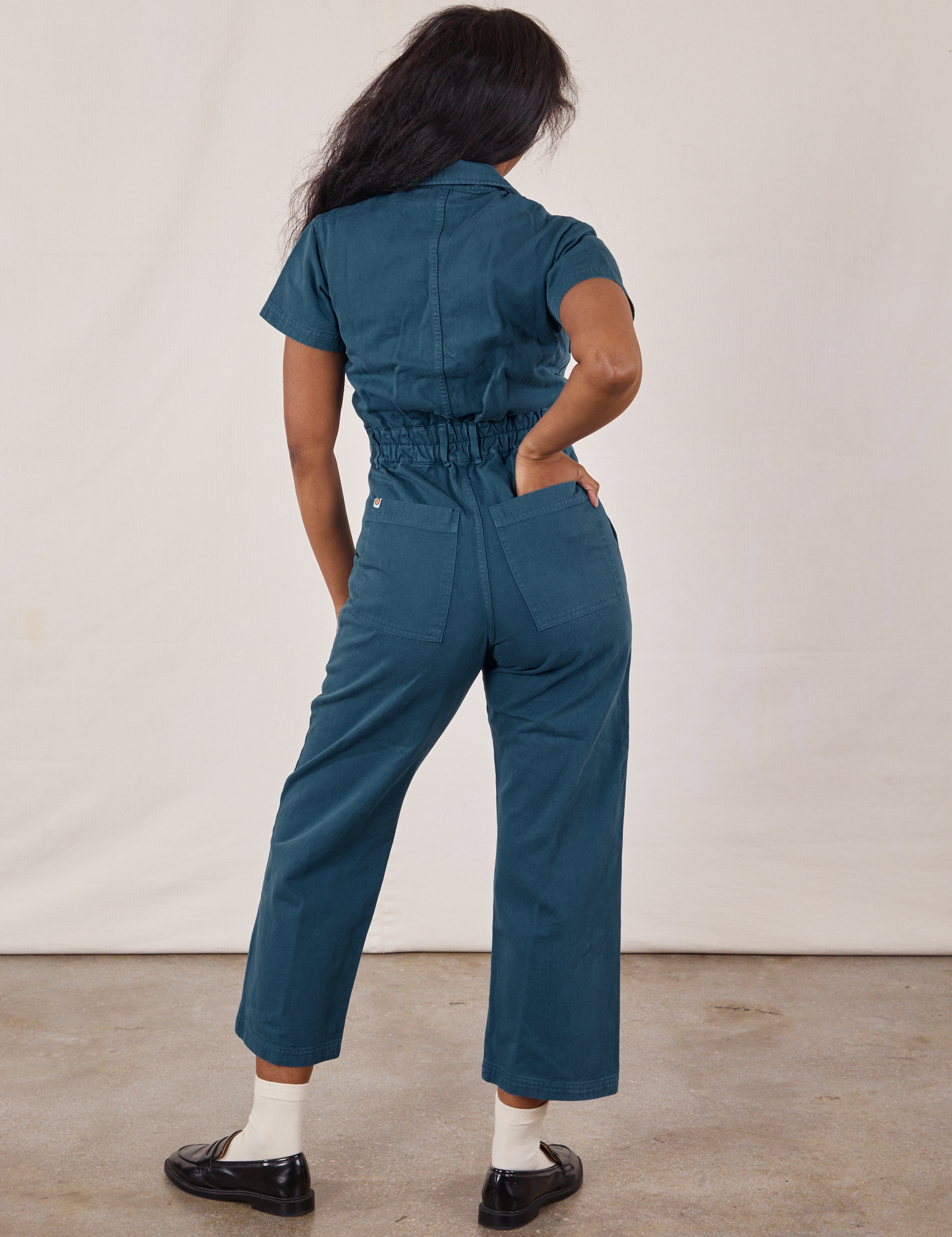 Petite Short Sleeve Jumpsuit in Lagoon back on Kandia. Kandia has her hand in the pocket.