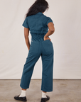 Petite Short Sleeve Jumpsuit in Lagoon back on Kandia. Kandia has her hand in the pocket.