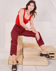 Alex is wearing Railroad Carpenter Jeans in Mustang Red and mustang red Square Neck Tank