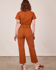 Back view of Short Sleeve Jumpsuit in Burnt Terracotta worn by Alex