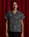 Anthony is wearing Spider Webs Pantry Button-Up