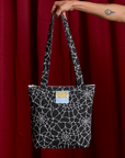 Spider Webs Printed Shoulder Zip Tote held by model