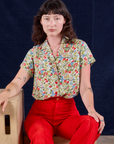 Off-White Strawberry Pantry Button-Up and mustang red Western Pants worn by Alex