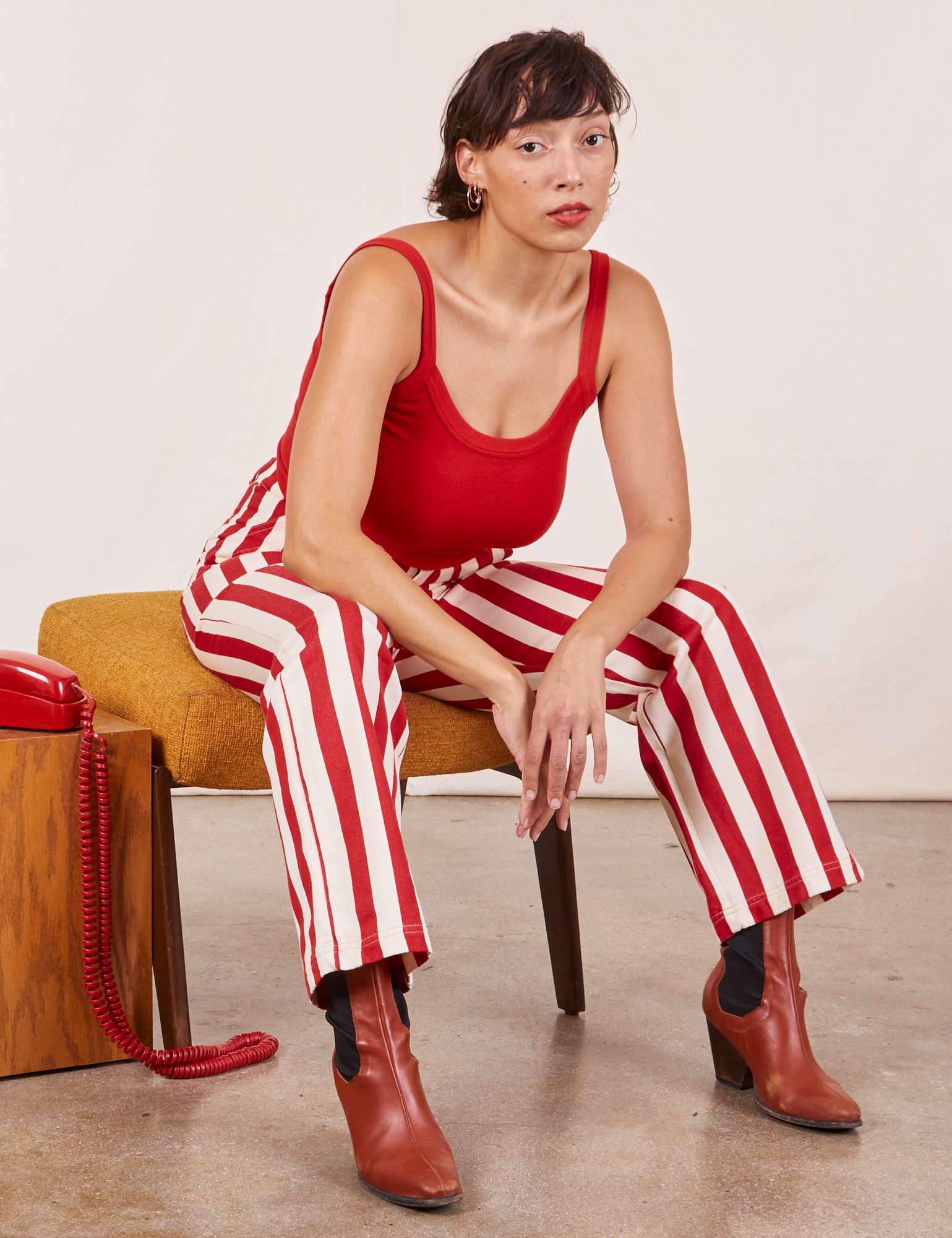 Tiara is wearing Work Pants in Cherry Stripe and mustang red Cropped Cami