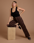 Tiara is wearing Black Stripe Work Pants in Fudgesicle Brown and black Cropped Tank