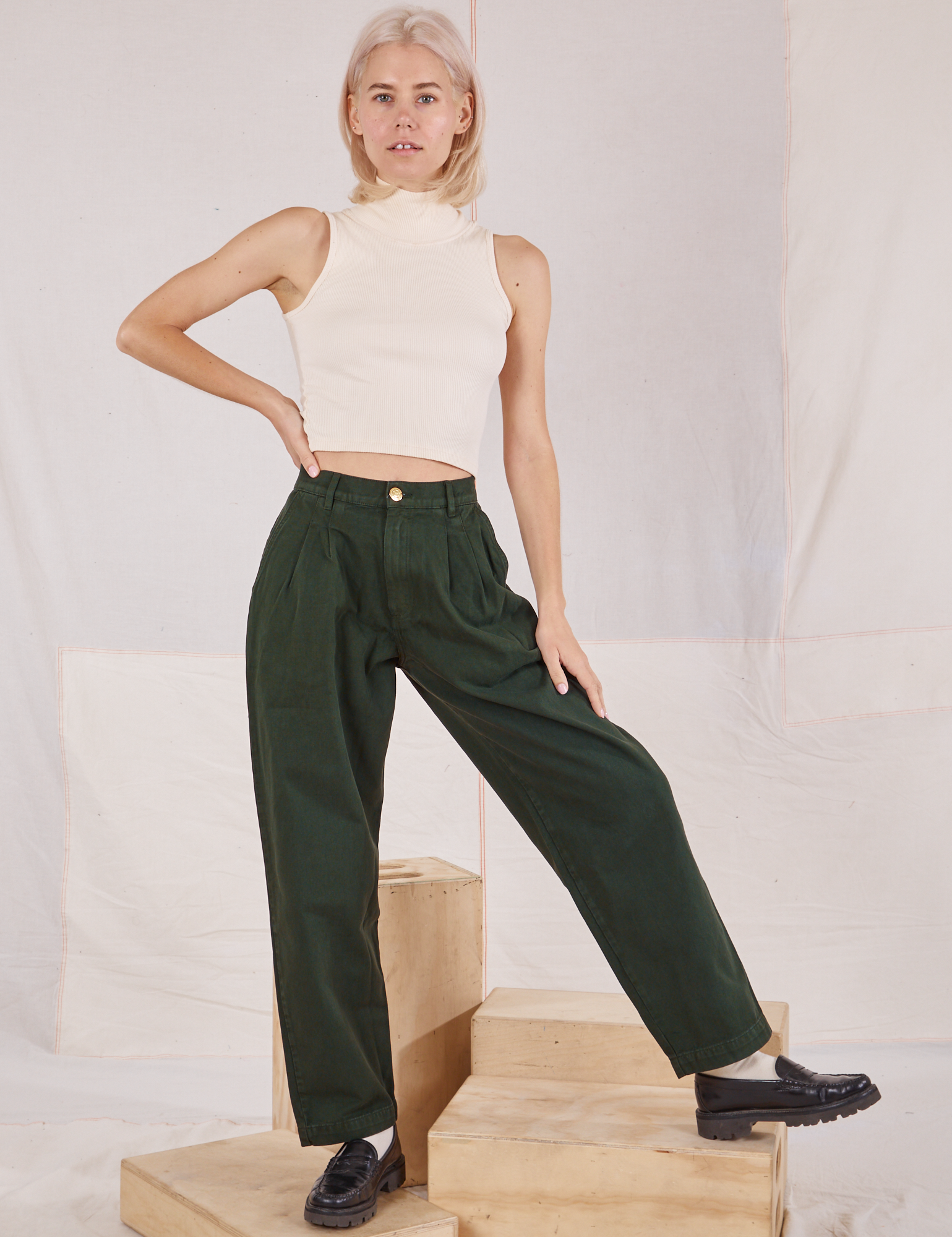Madeline is 5&#39;9&quot; and wearing XXS Heavyweight Trousers in Swamp Green paired with vintage tee off-white Sleeveless Turtleneck