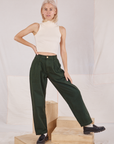 Madeline is 5'9" and wearing XXS Heavyweight Trousers in Swamp Green paired with Sleeveless Turtleneck in vintage tee off-white 