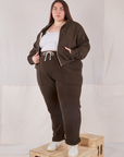 Marielena is 5'8" and wearing 1XL Rolled Cuff Sweat Pants in Espresso Brown with matching Cropped Zip Hoodie and a Cropped Tank in vintage tee off-white underneath.