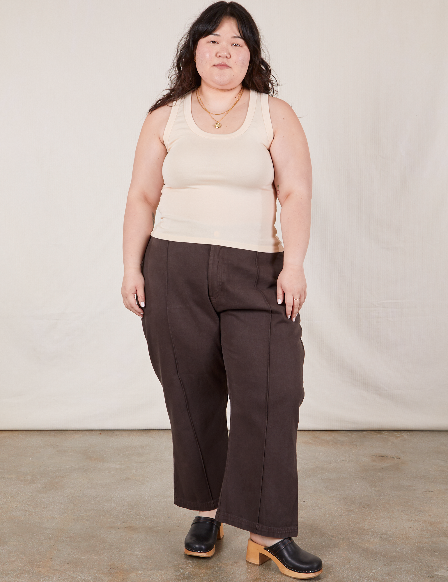 Ashley is 5’7” and wearing L Tank Top in Vintage Tee Off-White paired with espresso brown Western Pants
