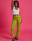 Kandia is 5'3" and wearing XS Checkerboard Work Pants in Green/Yellow paired with Cropped Tank in vintage tee white