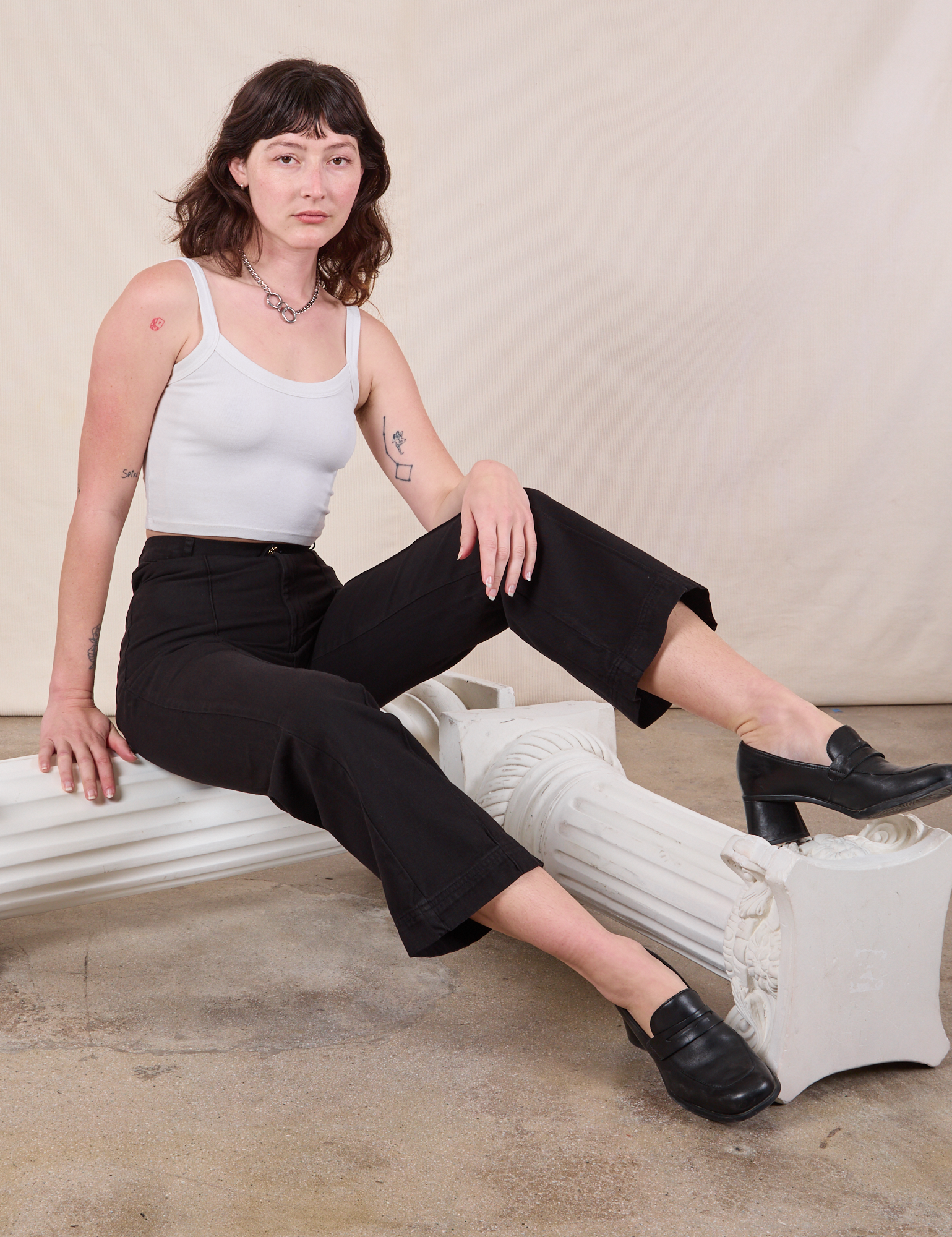 Alex is wearing Western Pants in Basic Black and Cropped Cami in vintage tee off-white