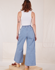 Back view of Indigo Wide Leg Trousers in Light Wash and vintage off-white Cropped Tank Top on Alex