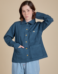 Hana is wearing a buttoned up Denim Work Jacket in French Blue