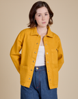 Hana is 5'3" and wearing P Denim Work Jacket in Mustard Yellow
